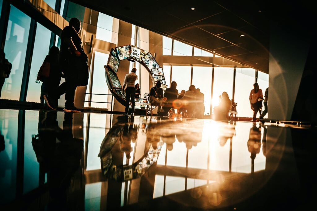 pexels-photo-705792-705792 Silhouette of people enjoying sunset views from a modern skyscraper in New York City.